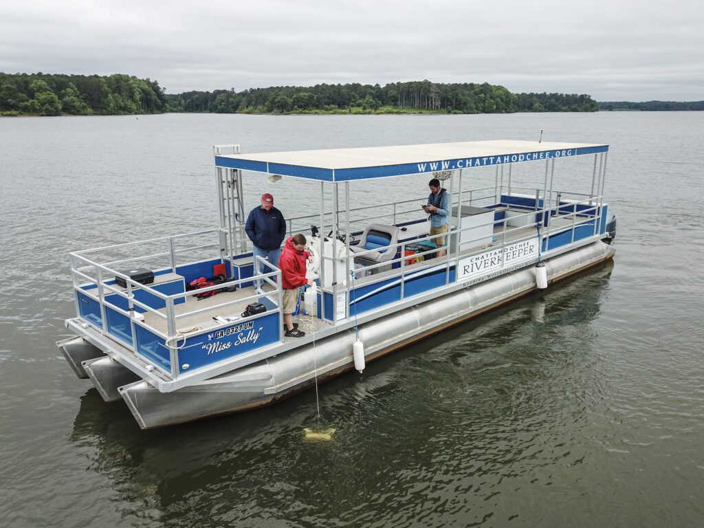 CRK staff members conduct water sample collection aboard "Miss Sally" on West Point Lake.