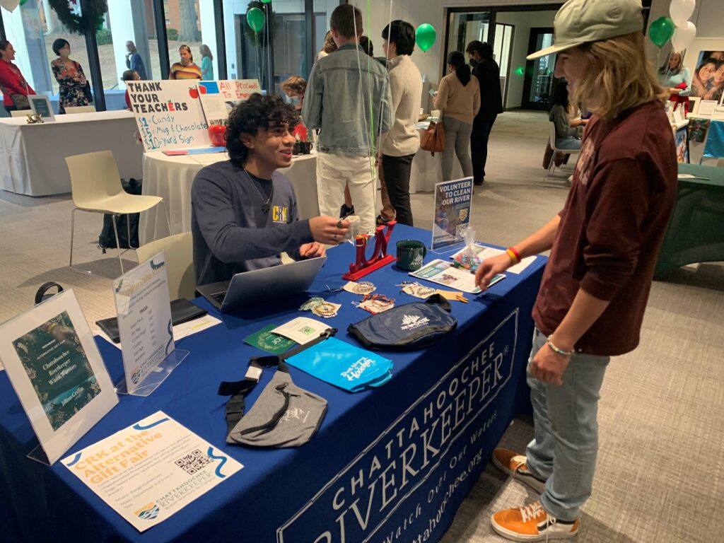 A Water Warrior leads conversations about water conservation at a school fair.